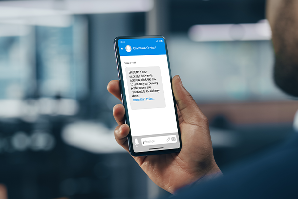 Smishing text on a man's phone