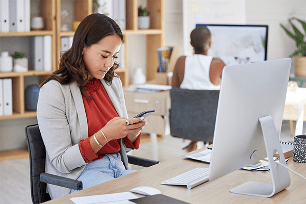 Woman on her phone at work