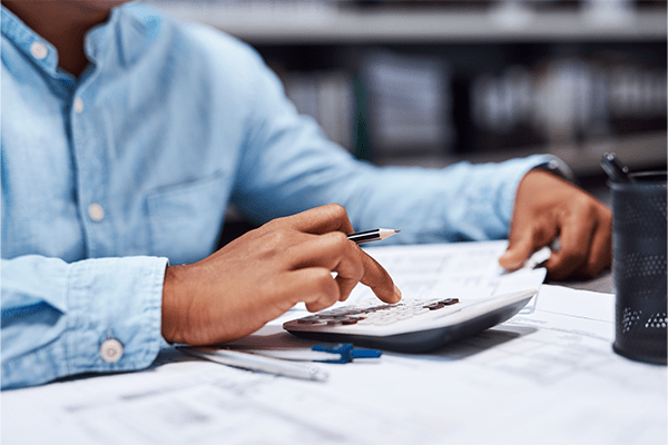Person using calculator at desk
