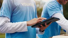 Volunteers using a tablet