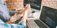 Two men developing software