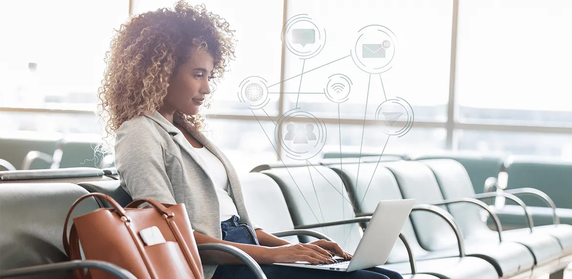 Woman working on a laptop in an airport